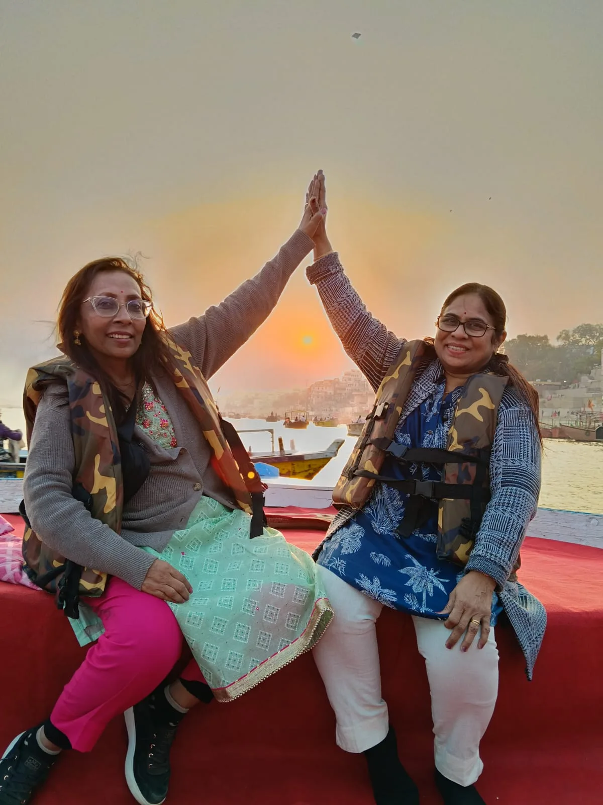 Silhouette prayer on a boat at sunset