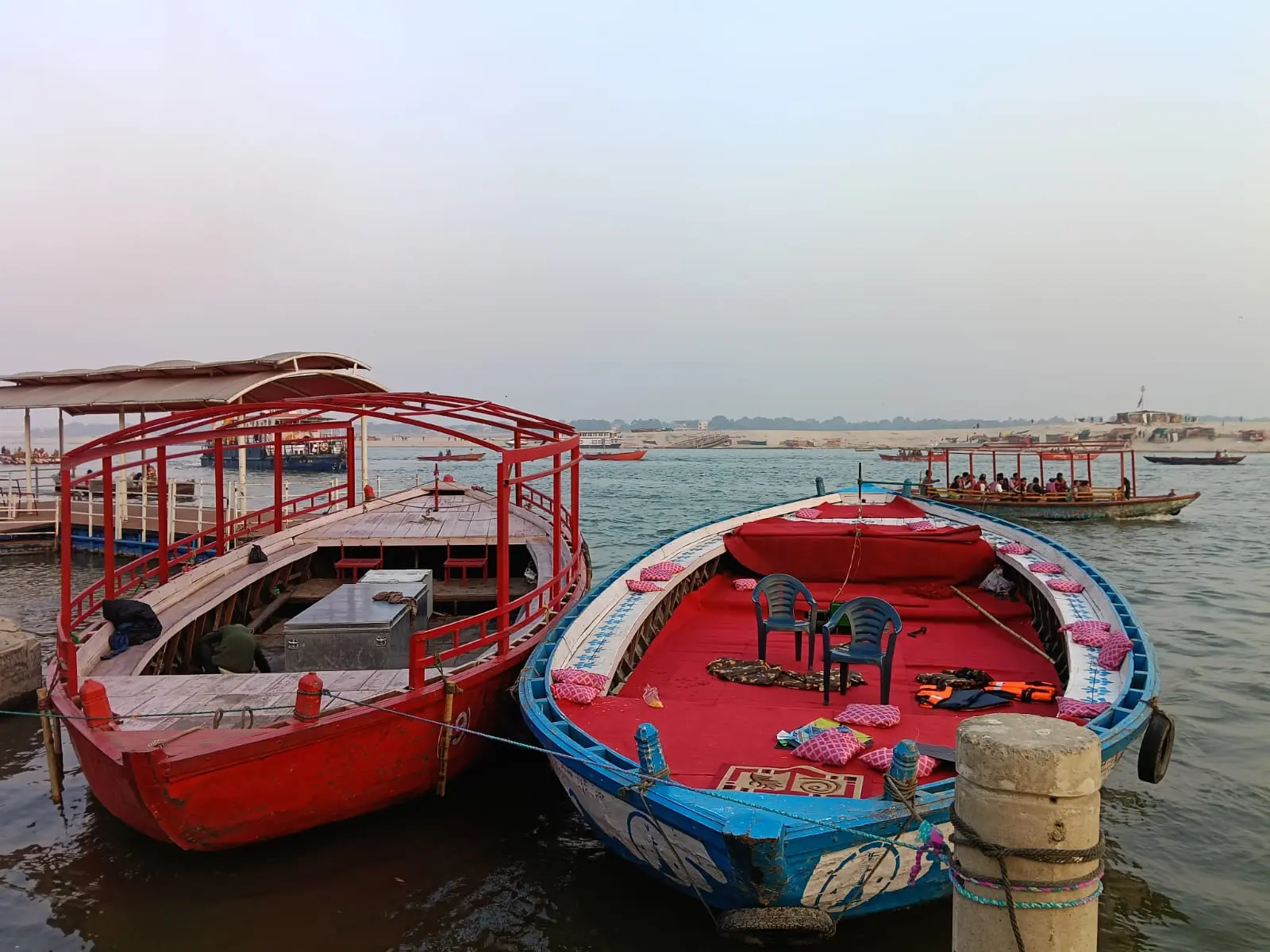 Two Ganga boats docked side by side at sunset