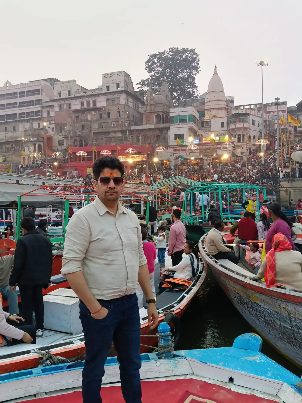 Boats lined up along a busy Varanasi ghat
