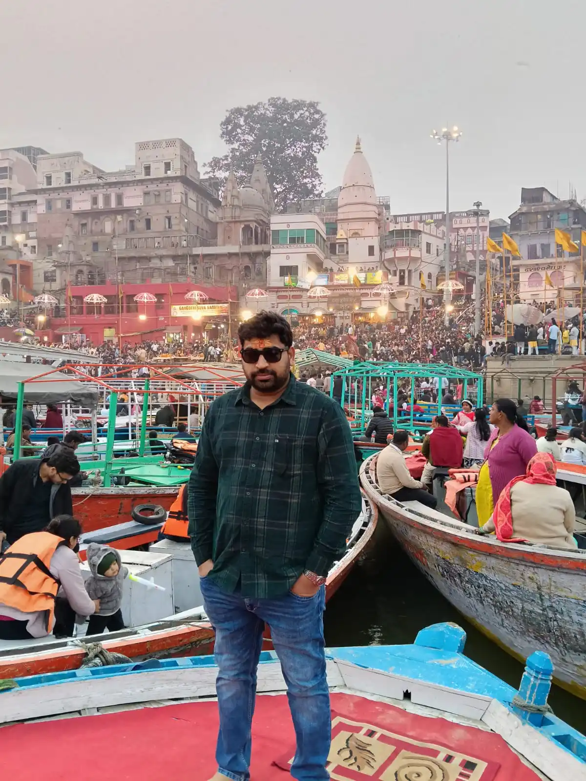 Riverside view of a crowded Varanasi ghat with boats